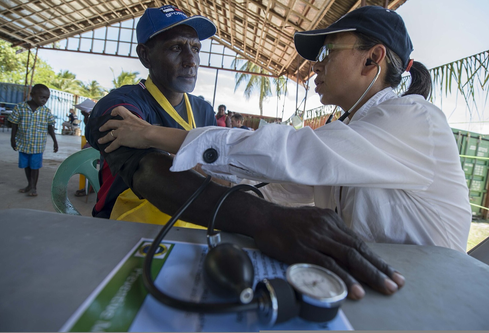 A volunteer checks a man’s blood pressure